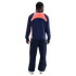 Rear view of a person wearing a navy tracksuit with a bright orange panel across the upper back, against a black background.