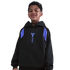 A smiling young boy with curly hair wearing a black Nike hoodie with a blue Kobe Bryant logo and "FC Barcelona" text, isolated against a solid black background.