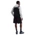 Rear view of a man in a grey hoodie, black vest, black cargo shorts, and sneakers against a black background.