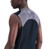 Back-angle view of a person wearing a grey and black Nike sleeveless mesh athletic top, set against a solid black background.