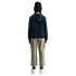 Rear view of a person wearing a black beanie, navy hoodie, tan cargo pants, and white sneakers against a black background.