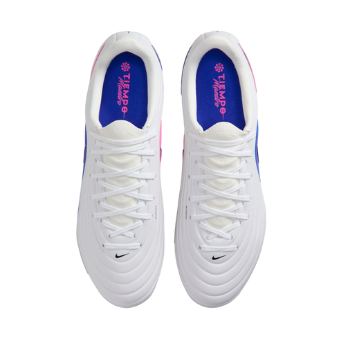 Top-down view of white Nike Tiempo Maestro soccer cleats with blue insoles, pink accents, and white laces against a black background.