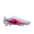 A white Nike soccer cleat with a bright pink midsection and a black swoosh outlined in blue. It features white laces and translucent studs, shown from a side profile against a black background.
