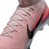 Close-up of a pink Nike soccer cleat with a textured Flyknit upper, pink laces, a large black swoosh, and a vibrant color gradient.