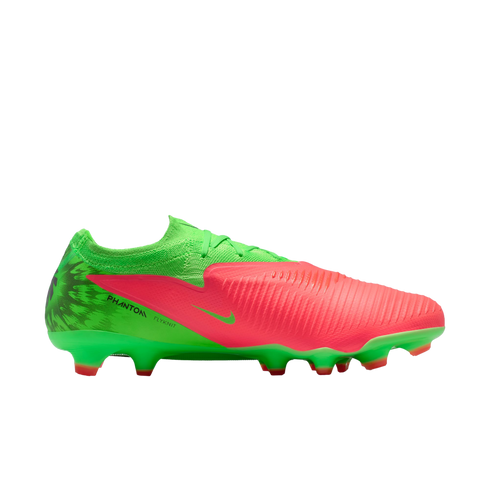 A side profile of a Nike Phantom Flyknit soccer cleat in vibrant lime green and bright coral pink, set against a solid black background.