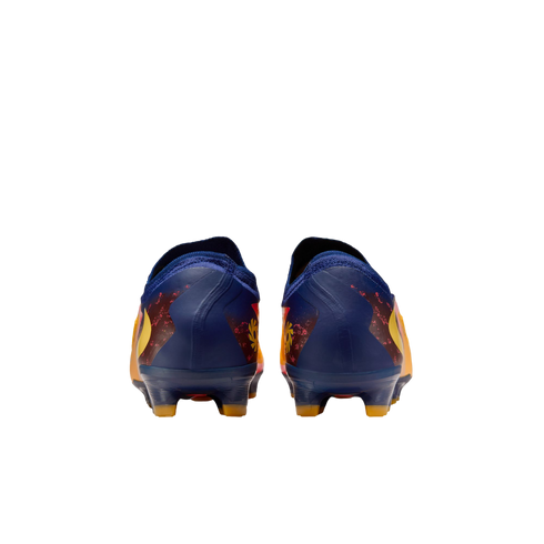 Rear view of a pair of dark blue soccer cleats with vibrant yellow and orange designs, set against a solid black background.