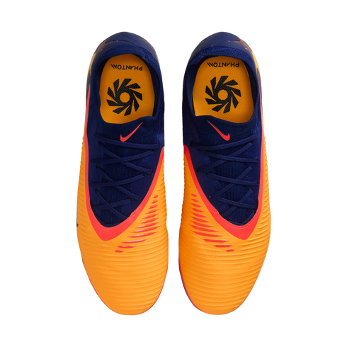 Top-down view of orange and navy blue Nike Phantom soccer cleats with red accents, displayed on a black background.