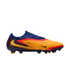 Side view of a colorful Nike soccer cleat in orange, red, and blue with a textured upper and yellow swoosh logo.