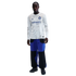 A young Black man with braids wears a long-sleeve white jersey with gray patterns and a "betsson .sport" logo, blue and black pants, and dark sneakers, standing against a black background.