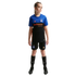 Young girl in a blue, black, and orange soccer kit featuring Inter Milan and betsson logos, standing against a black background.