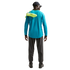 Rear view of a person in a blue long-sleeved shirt and grey trousers, carrying neon yellow soccer cleats over their shoulder against a black background.