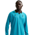 A man wearing a long-sleeved, bright blue Tottenham Hotspur soccer jersey with a black and yellow collar, set against a black background.
