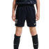 A front-facing view of a youth athlete from the waist down wearing navy blue USA national team soccer shorts and matching knee-high Nike socks against a black background.