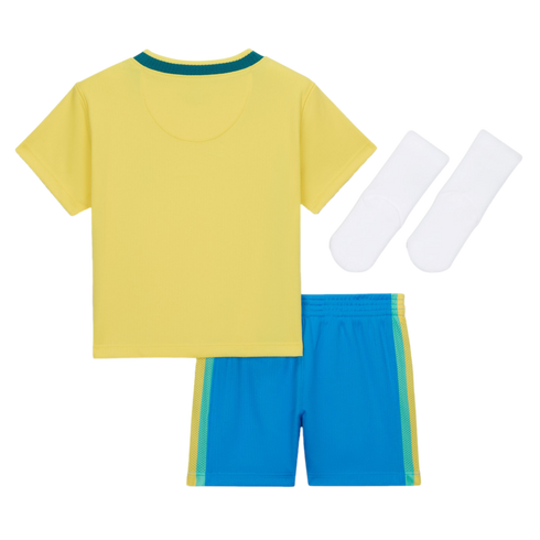 A flat lay of a children's sports uniform against a black background, featuring a yellow short-sleeved jersey with a teal collar, bright blue shorts with teal and yellow side stripes, and a pair of white socks.