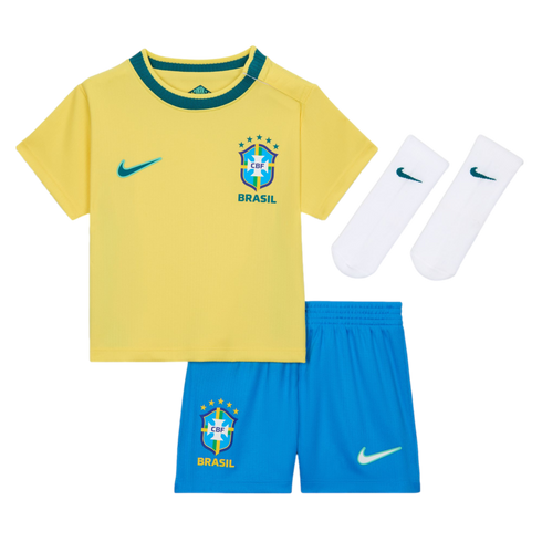 A three-piece baby or toddler Brazil national soccer team kit by Nike, consisting of a yellow short-sleeved jersey with a green collar, blue elastic-waist shorts, and a pair of white crew socks, all displayed against a black background. Each piece feature