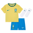 A three-piece baby or toddler Brazil national soccer team kit by Nike, consisting of a yellow short-sleeved jersey with a green collar, blue elastic-waist shorts, and a pair of white crew socks, all displayed against a black background. Each piece feature