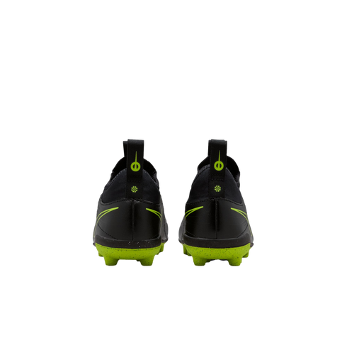 A rear view of a pair of black Nike soccer cleats with bright lime green soles and accents against a solid black background.