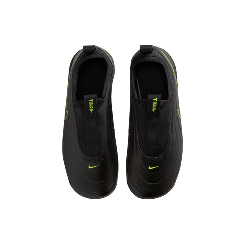 A top-down view of a pair of black Nike Tiempo slip-on athletic shoes against a solid black background. The matte black shoes feature vibrant neon green accents, including small Nike swooshes on the toes and "TIEMPO" text on the front pull tabs.