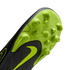 A close-up of the neon green and black sole of a Nike soccer cleat, showing molded studs and a green swoosh logo.