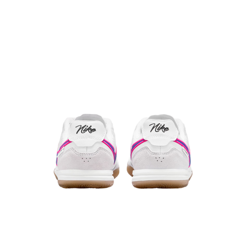 Rear view of white Nike sneakers with pink and blue accents, cursive heel logos, and gum outsoles against a black background.