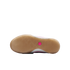 Bottom view of a Nike shoe featuring a gum rubber sole with a herringbone tread and a small pink hexagonal logo in the center.