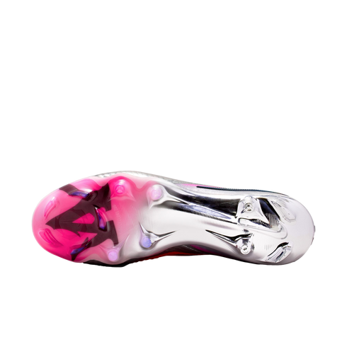 Underside of a Nike soccer cleat showing a metallic silver and pink soleplate with circular studs against a black background.