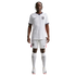A full-body photograph of a male athlete standing against a solid black background, wearing the white Nike England national team home soccer kit. The kit includes a white jersey and shorts featuring the team's Three Lions crest and Nike logo, paired with