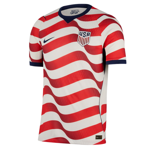 A Nike USA soccer jersey with red and white wavy horizontal stripes, navy blue collar and cuffs, and the team crest on the chest.