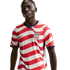 A man wearing a USA soccer jersey with red and white wavy stripes, featuring a Nike swoosh and USA crest, against a solid black background.