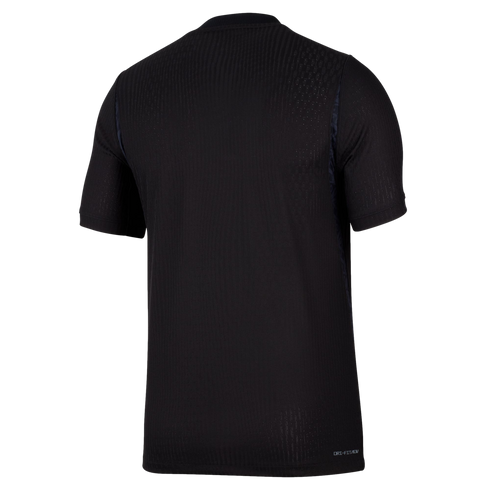 Back view of a black short-sleeved Nike Dri-FIT ADV t-shirt featuring a subtle vertically ribbed texture, set against a plain black background.