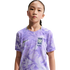 Portrait of a young girl wearing a light purple patterned Nike South Korea national team soccer jersey against a solid black background.