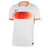 A white short-sleeved Nike football jersey featuring a wide horizontal band across the chest in varying shades of orange. Centered on the band is the Netherlands KNVB lion crest, with an orange Nike swoosh on the upper right chest and orange trim on the c