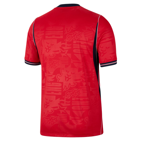 Back view of a red short-sleeve soccer jersey featuring a tonal lion and "ENG" pattern, navy blue side panels with white piping, and navy-striped sleeve cuffs.