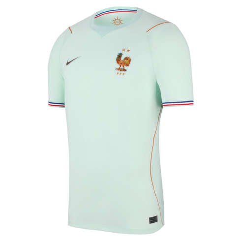 Mint green Nike France football jersey with gold FFF rooster crest, two stars, gold piping, and tricolor sleeve trim.