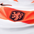 Close-up of a Nike Netherlands national football team jersey, featuring a white base with a diagonal orange stripe and the black and orange KNVB lion crest.