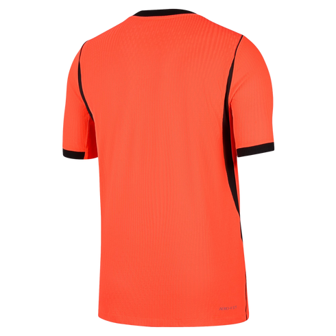A back view of a vibrant orange short-sleeved athletic jersey with black trim on the collar, sleeve cuffs, and side panels. The shirt features a vertical ribbed texture and small blue "AERO-FIT" text at the bottom right hem.