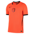 A bright orange Nike Netherlands national football team jersey featuring a central KNVB lion crest, black trim on the collar and sleeve cuffs, and a vertical ribbed texture.