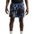 A person wearing Nike athletic shorts with a blue, black, and grey pixelated abstract pattern and white Nike socks, shown from the waist down against a plain white background.