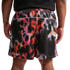 Back view of a person wearing a black shirt and shorts with a vibrant, pixelated abstract print in red, pink, orange, and white.