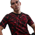 A man wearing a black Nike Atlético Madrid jersey featuring an abstract red geometric line pattern.