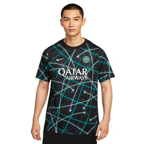 A man wearing a black Inter Milan soccer jersey with a teal geometric constellation pattern and white Qatar Airways logo, set against a plain white background.