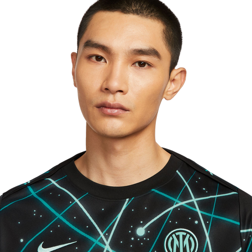 Portrait of a man wearing a black Nike Inter Milan soccer jersey with a teal cosmic pattern against a white background.