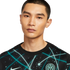 Portrait of a man wearing a black Nike Inter Milan soccer jersey with a teal cosmic pattern against a white background.