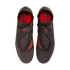 A top-down view of a pair of black Nike Phantom laceless soccer cleats with bright orange accents and a textured upper against a black background.