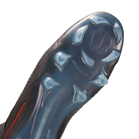 A close-up view of the semi-transparent blue soleplate of a black Nike soccer cleat, featuring the "NIKE CYCLONE 360" traction pattern and stud configuration.