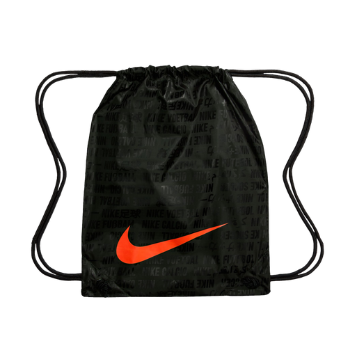 A black Nike drawstring bag with a large bright orange swoosh on the front. The bag features a subtle, repeating pattern of the word "Nike" alongside words for "soccer" in various languages. Two black drawstrings at the top serve as a cinch closure and sh