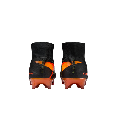 Rear view of black and orange Nike Mercurial soccer cleats with a high-cut knit collar, set against a solid black background.
