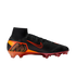 A side view of a Nike Mercurial Superfly soccer cleat featuring a black knit upper and a high-top collar. An orange Nike Swoosh with a red outline is on the side, and a large bronze "M" logo is set into an orange and red graphic on the heel. The soleplate