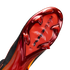 A close-up of the metallic red and orange soleplate of a Nike soccer cleat, featuring chevron-shaped studs and "AIR ZOOM" branding, set against a solid black background.