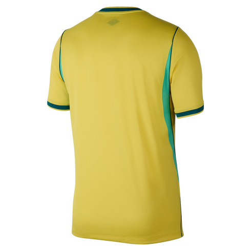 Rear view of a yellow short-sleeved jersey with green trim on the collar and sleeve cuffs, and green panels on the sides, set against a black background.